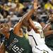 Michigan junior Tim Hardaway Jr. holds off Cleveland State sophomore Anton Grady, left, and sophomore Charlie Lee as they battle under the basket during the first half of an NIT Season Tip-Off game at Crisler Center on Tuesday. Melanie Maxwell I AnnArbor.com